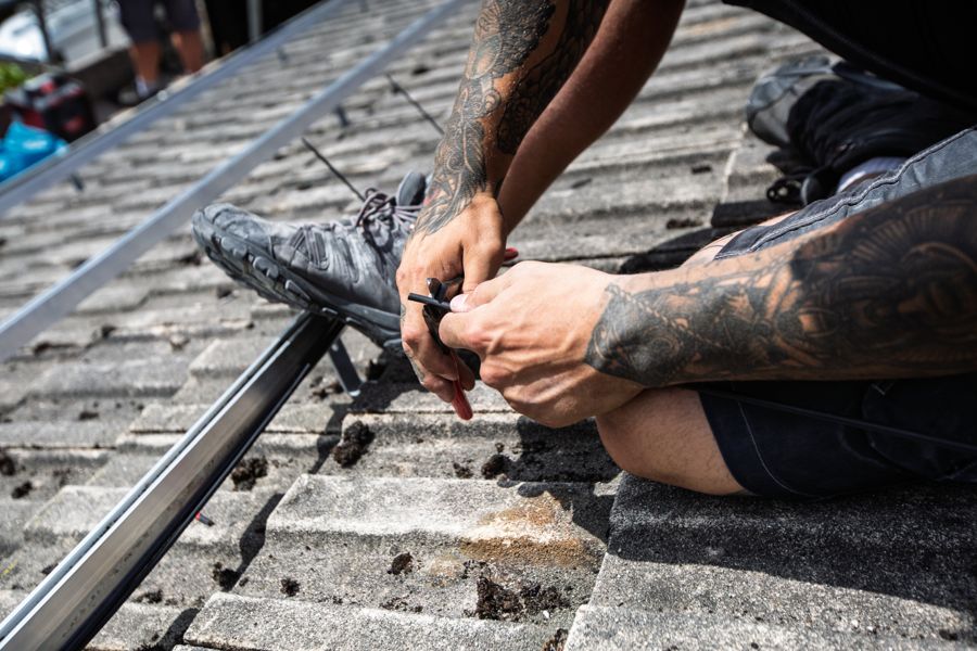 Close-up of cables being clipped and tidied on the roof