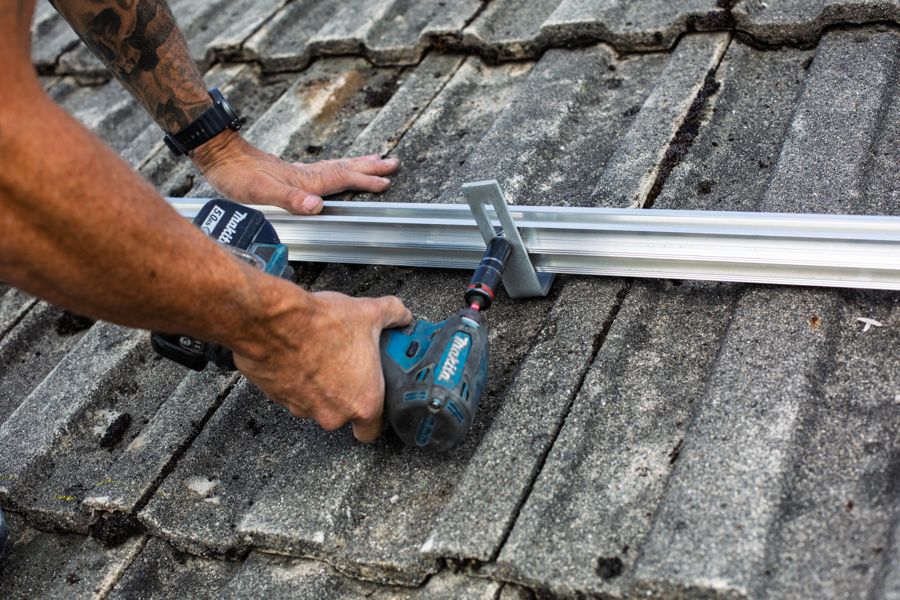 Drilling a rail clamp tight onto a roof hook