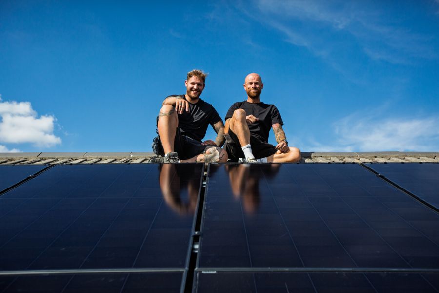 Two of the team sitting on the ridge above the finished panels